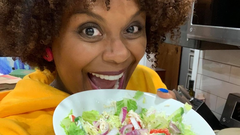 Tabitha Brown holding salad