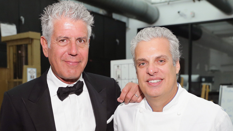 Eric Ripert and Anthony Bourdain smiling at event
