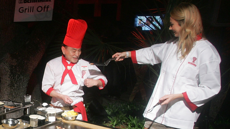 Benihana chefs training someone at an event