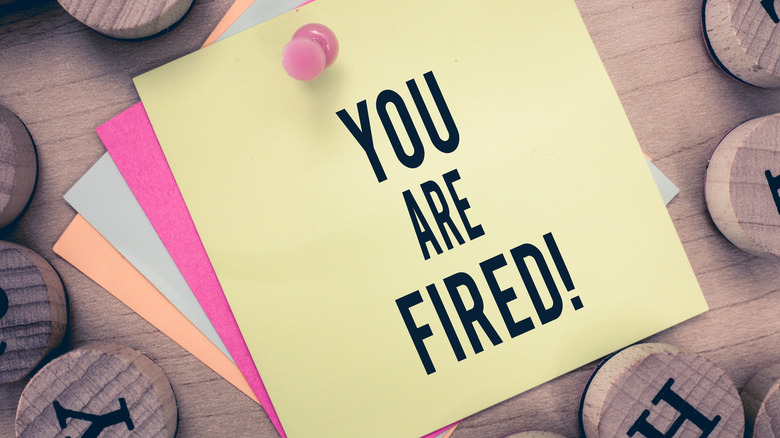 The message 'You are fired' on a Post-it note