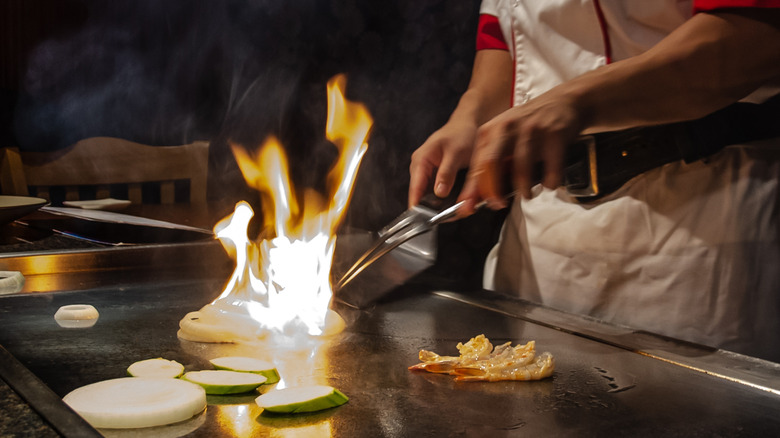 Food cooking on a teppanyaki chef's grill 