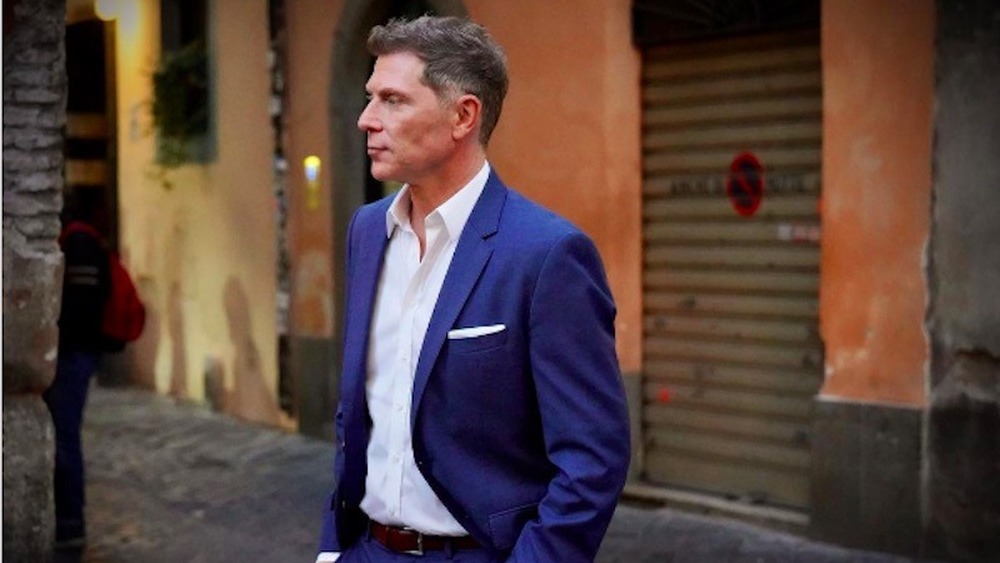 Bobby Flay wears a suit in Rome Italy