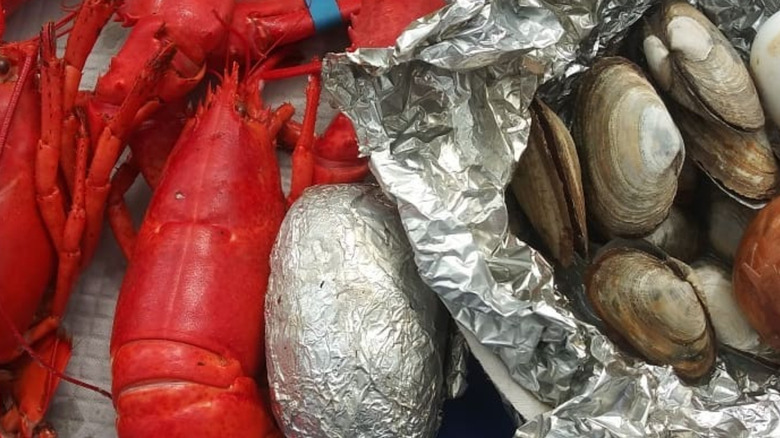 Lobsters, clams, and wrapped potatoes