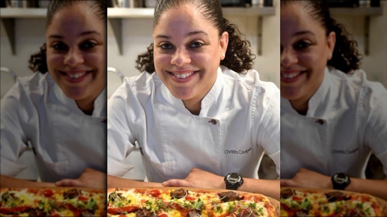 Christina Coupet smiling by a pizza