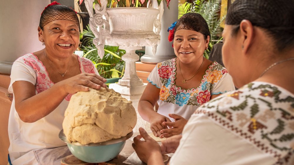 Mexican women making corn tortillas