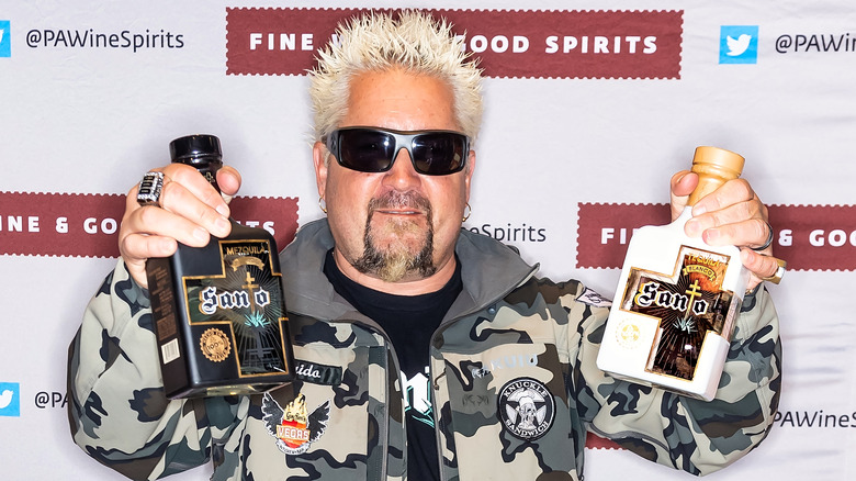 Guy Fieri holding up Santo