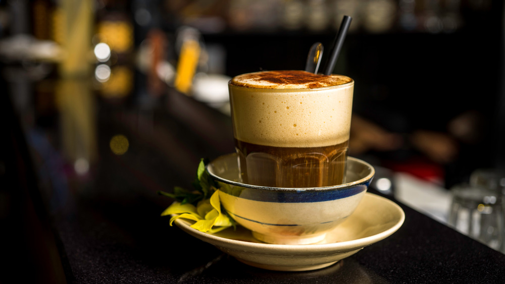 Glass of Vietnamese egg coffee in a bowl 