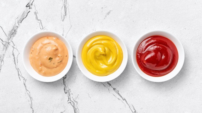 bowls of condiments on marble counter