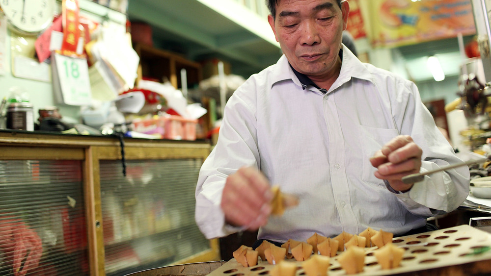 man making fortune cookies