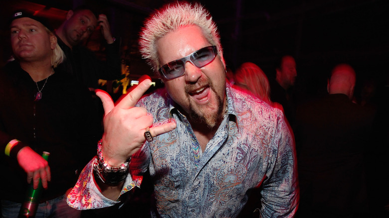 Guy Fieri gives the "ROCK ON" sign