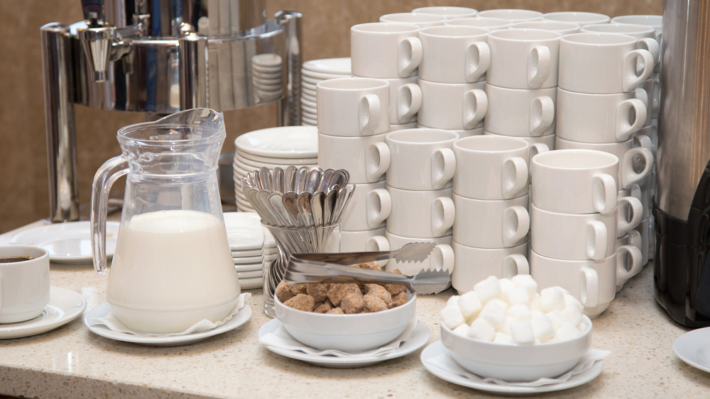 jug of milk and coffee mugs