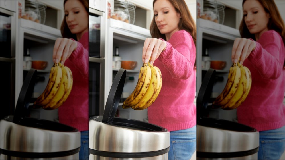 Woman throwing out banana