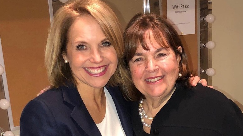 Katie Couric and Ina Garten smiling and embracing