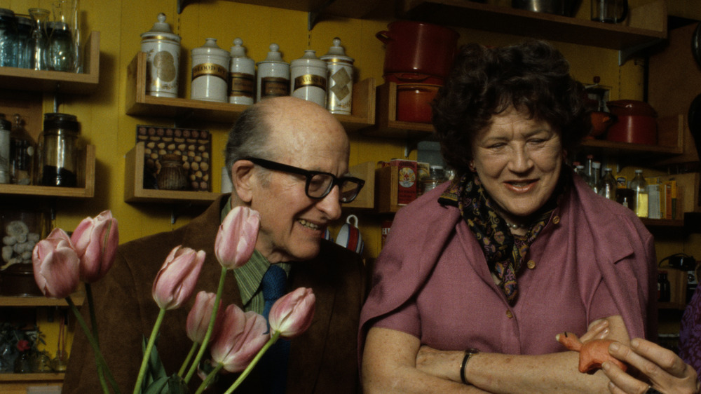 Paul and Julia Child in a kitchen with flowers 