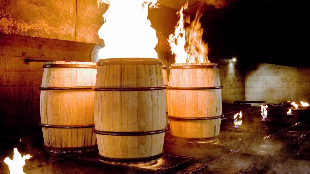 Bourbon barrels being charred for distilling