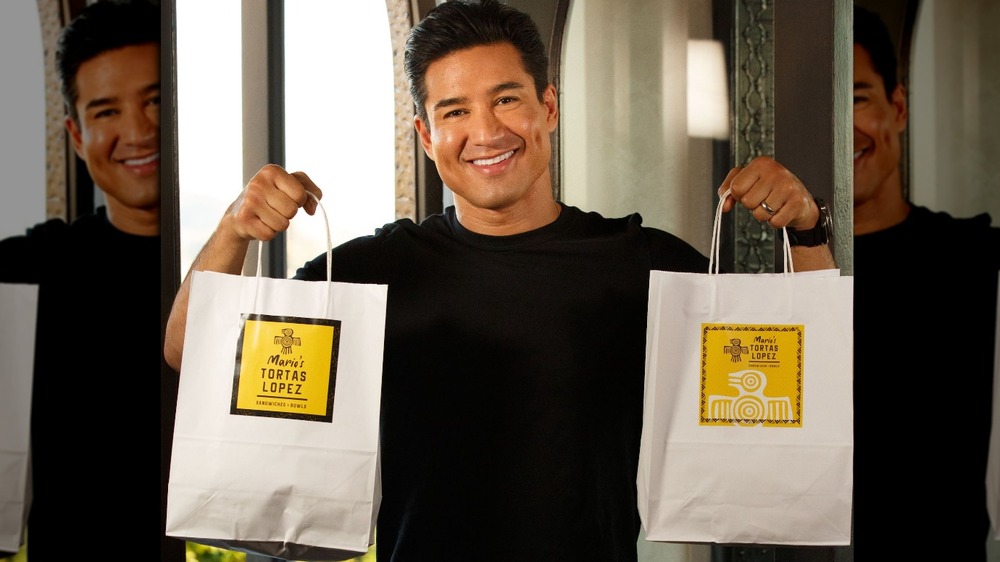 Mario Lopez holds a delivery bag