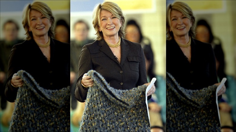 Martha Stewart holds up crocheted poncho