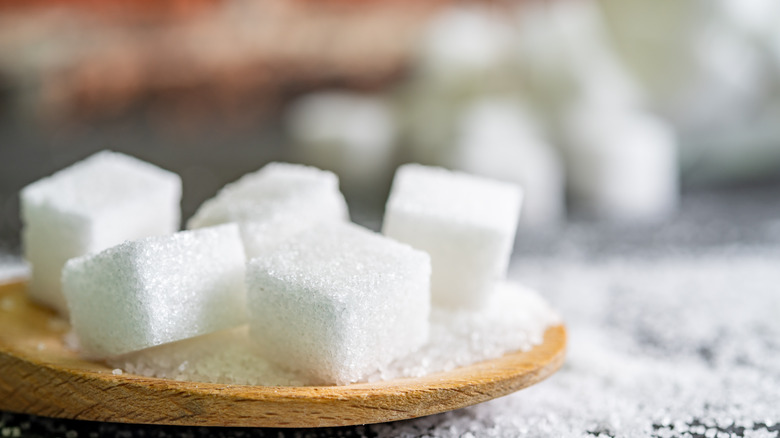 sugar cubes in wooden spoon