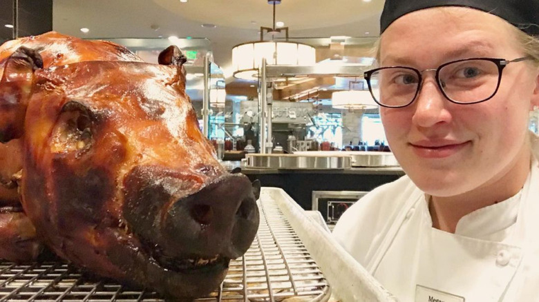 Chef Megan Gill posing for selfie with pig roast