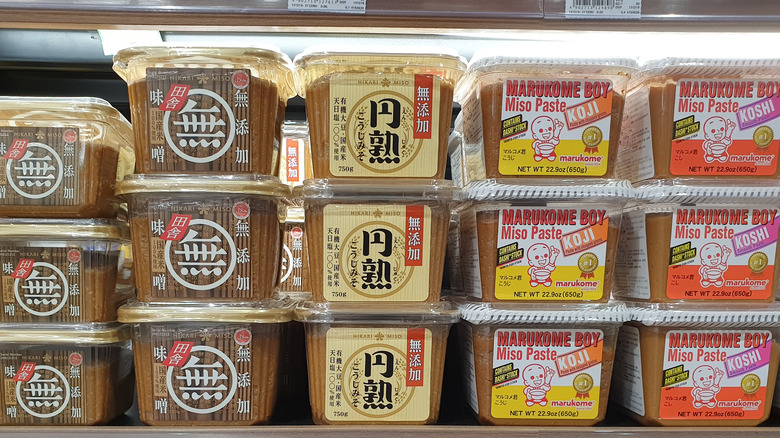 Tubs of miso paste in a grocery store