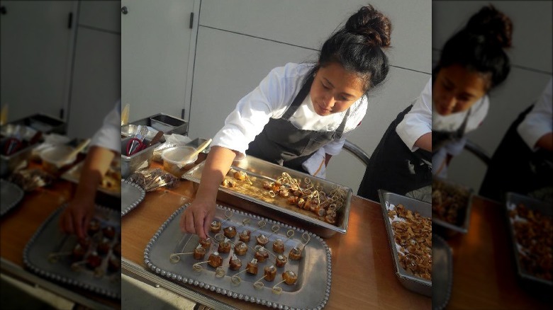 Monique Feybesse arranging a plate of food