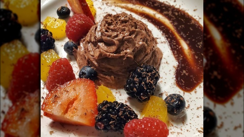 A chocolate dessert with sliced fruit