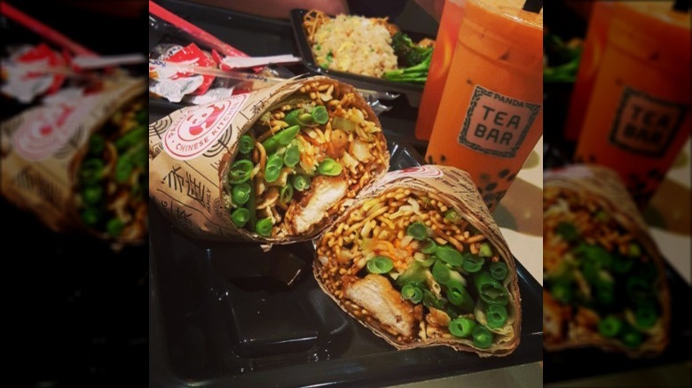 orange chicken burrito on tray with tea