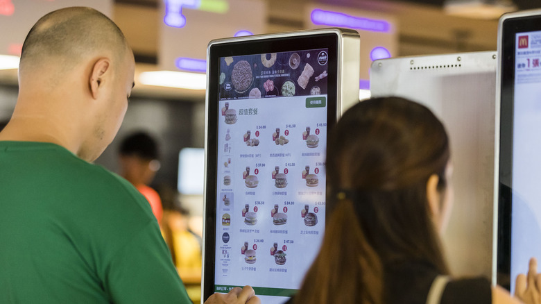 Custimers using McDonald's self-serve kiosks