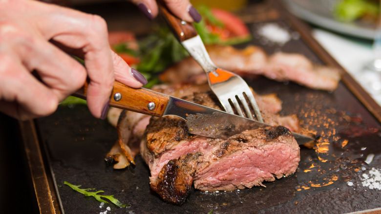 woman eating steak