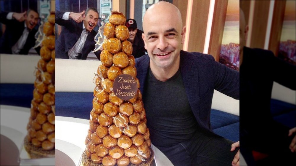 Adriano Zumbo posing with a croquembouche