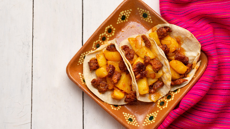 three chorizo and potato tacos