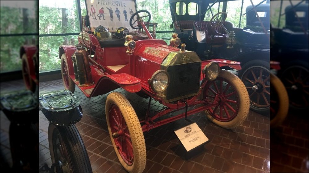 A classic firetruck and other vintage cars on the Chick-fil-A Backstage Tour