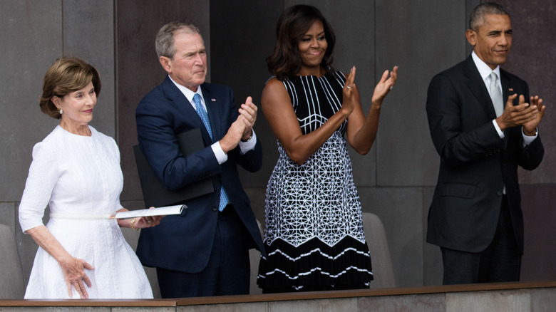 The Obamas and Bushes applauding