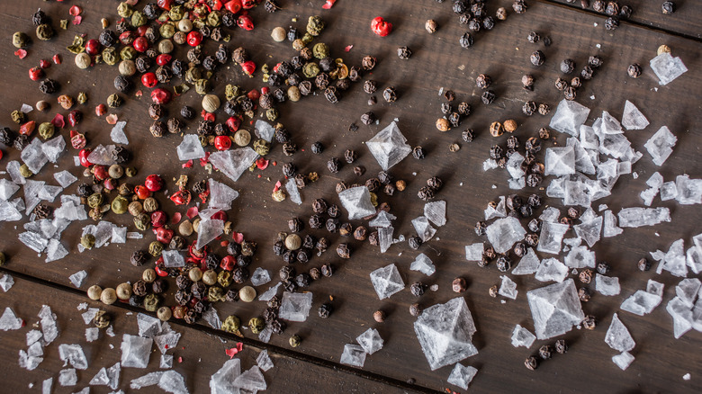 salt crystals and peppercorns