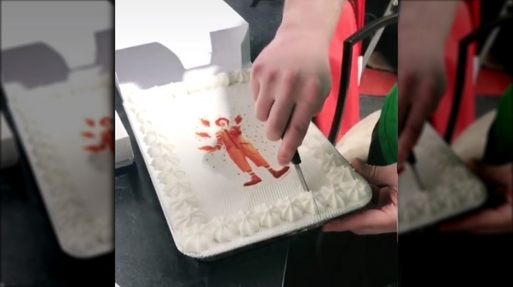 Hand cutting a McDonald's sheet cake