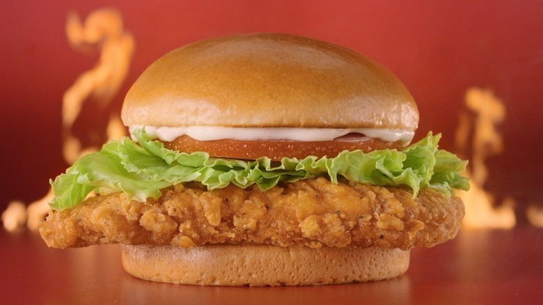 Wendy's spicy chicken sandwich flanked by fire
