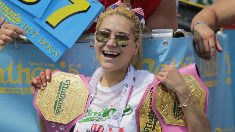 Miki Sudo holding championship belts