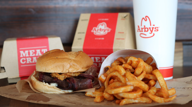 Arby's smokehouse brisket sandwich with drink and curly fries