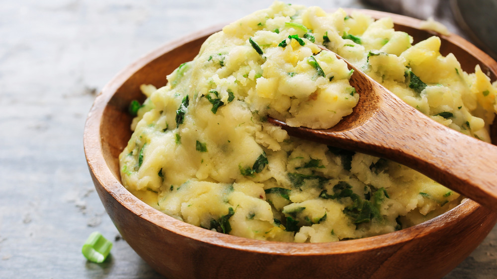 Bowl of colcannon and wood spoon