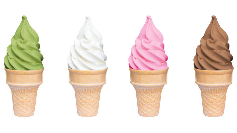 four soft serve ice cream cones on white background