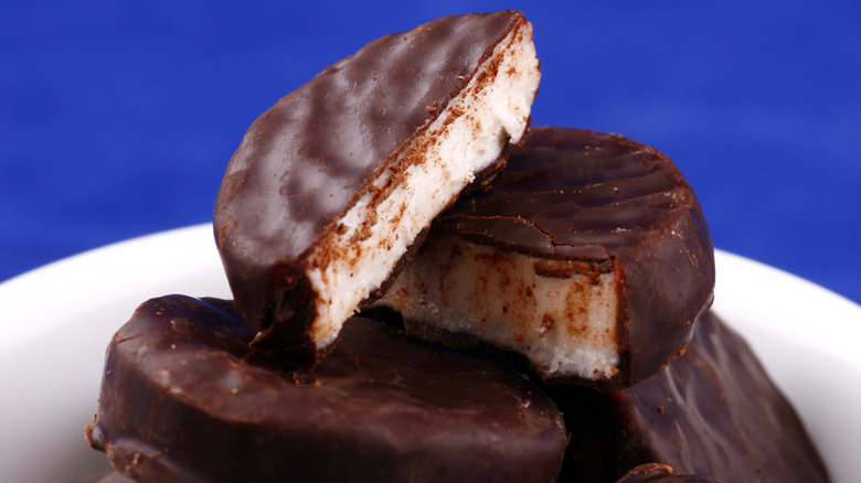 Close up of homemade peppermint patties in a bowl with a blue background