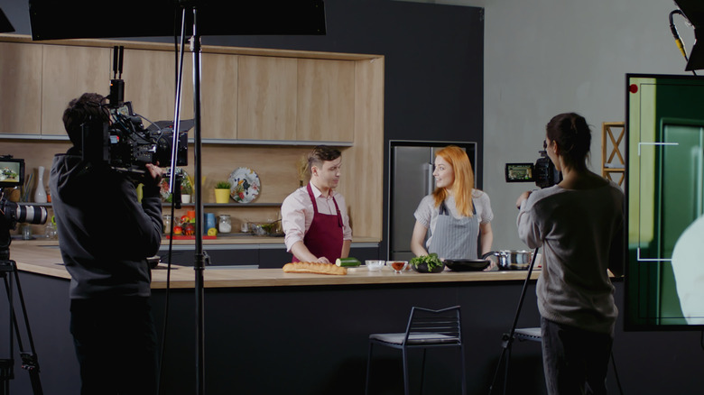 2 people filming cooking show