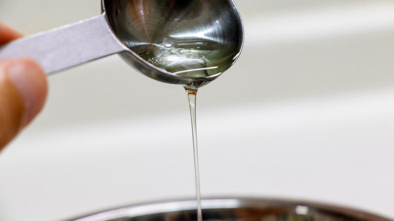 pouring liquid into baking measure