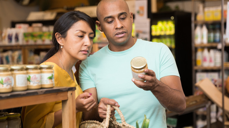 grocery shopping couple looking at ingredients