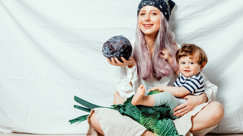 hippie mom with greens and child