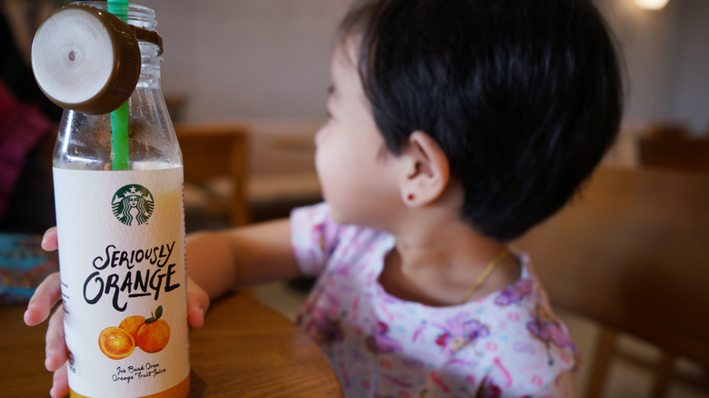 kid drinking juice at starbucks