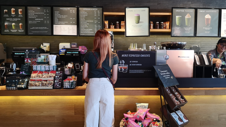 girl looking at starbucks menu