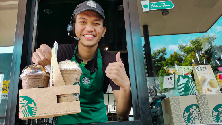 starbucks employee giving a thumbs up