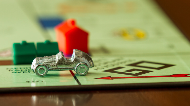 Monopoly board with car game piece