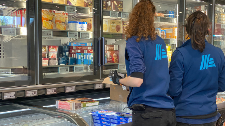 Aldi employees examining inventory